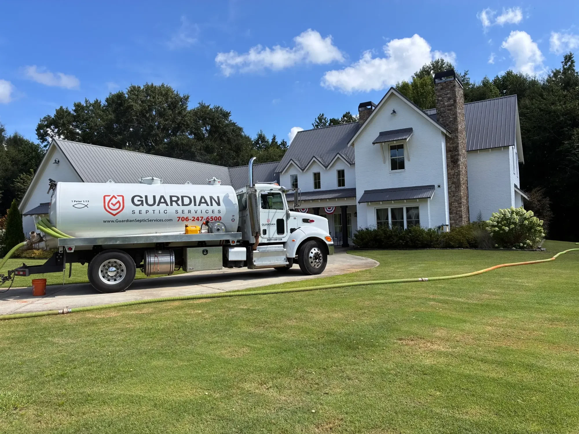 Guardian Septic Services vacuum truck pumping a septic tank at a northeast Georgia home