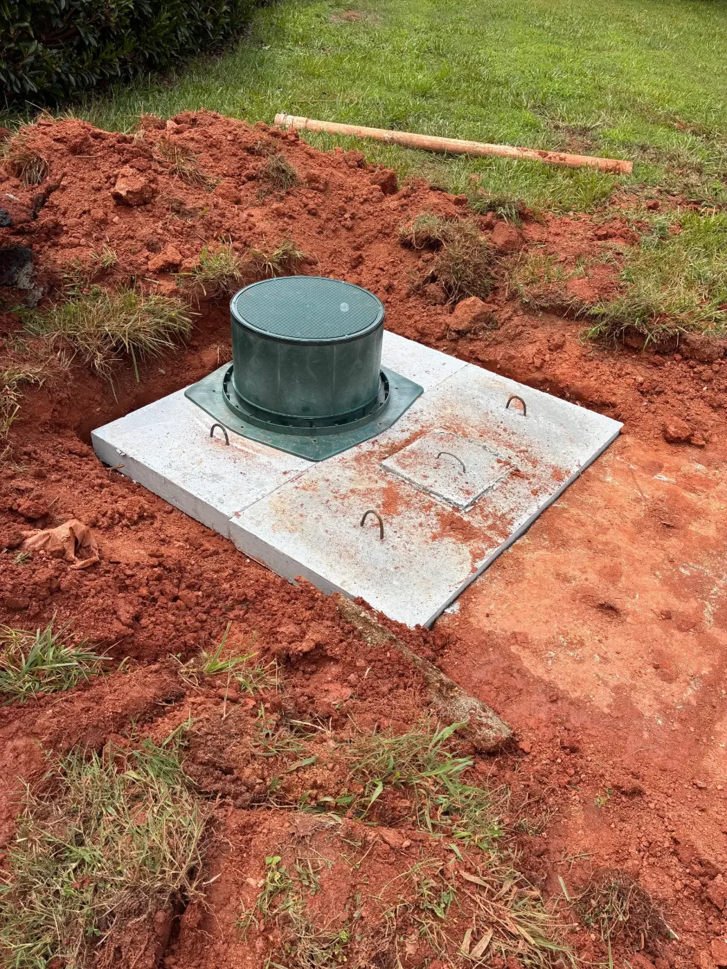 A serviced septic tank lid closed back up at the end of the job
